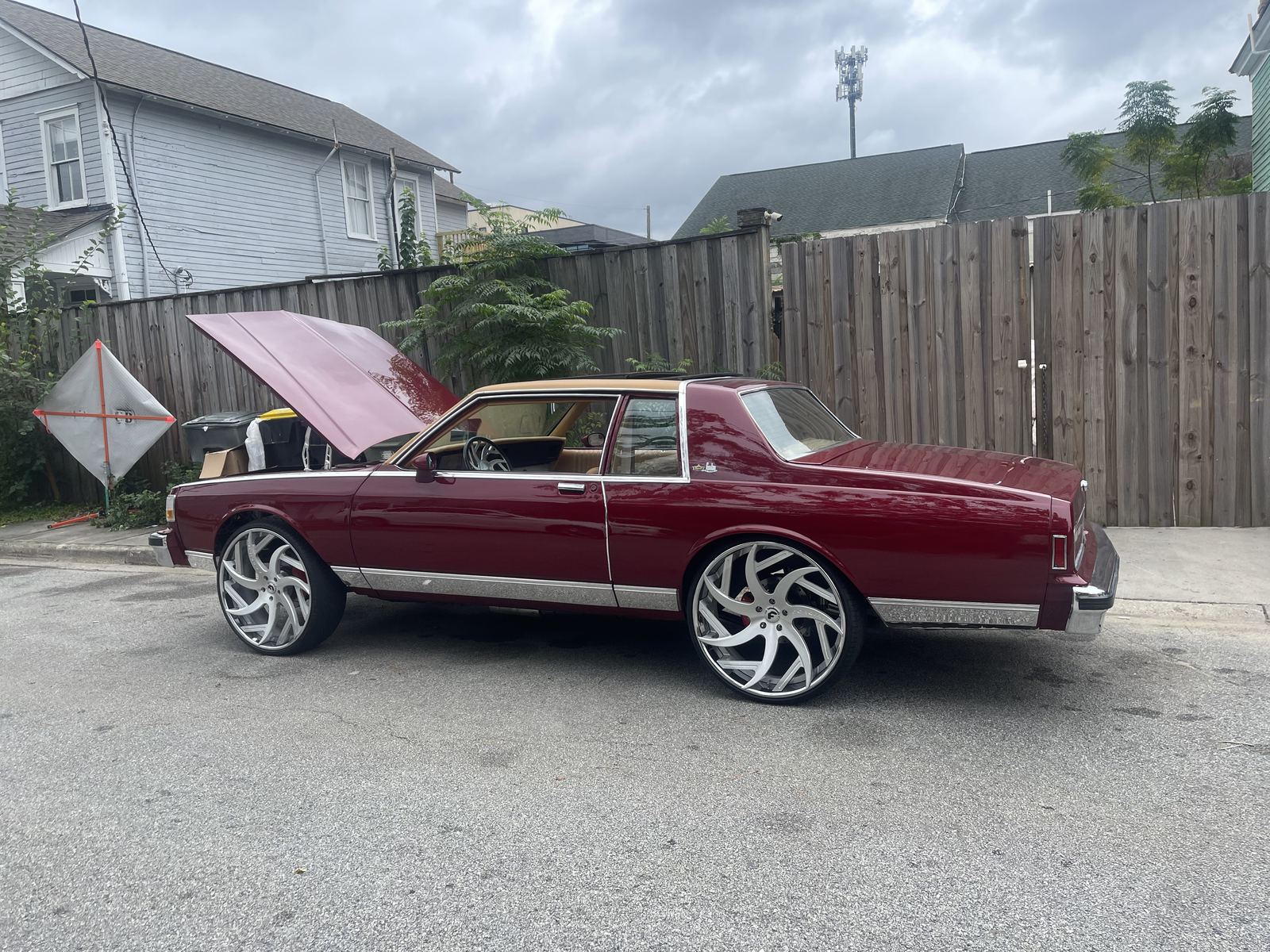 Burgundy Chevrolet Caprice coupe on custom wheels